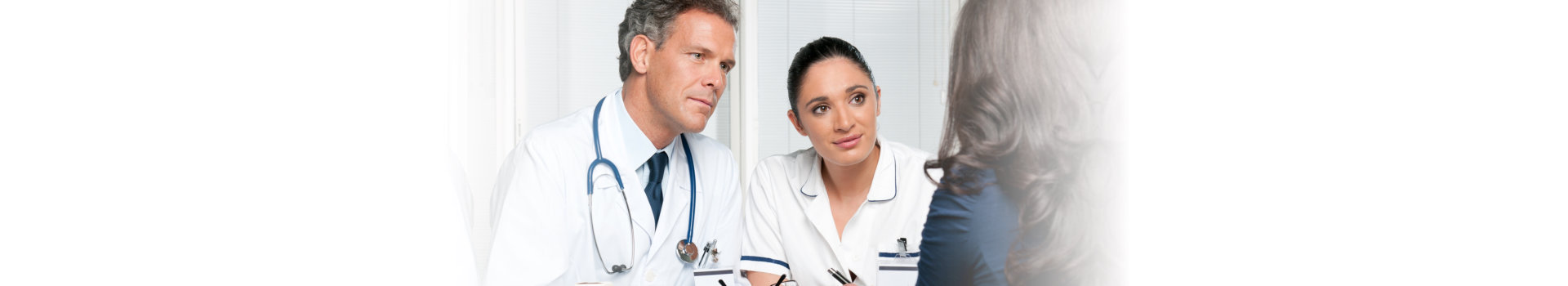 doctor and nursing talking to a patient